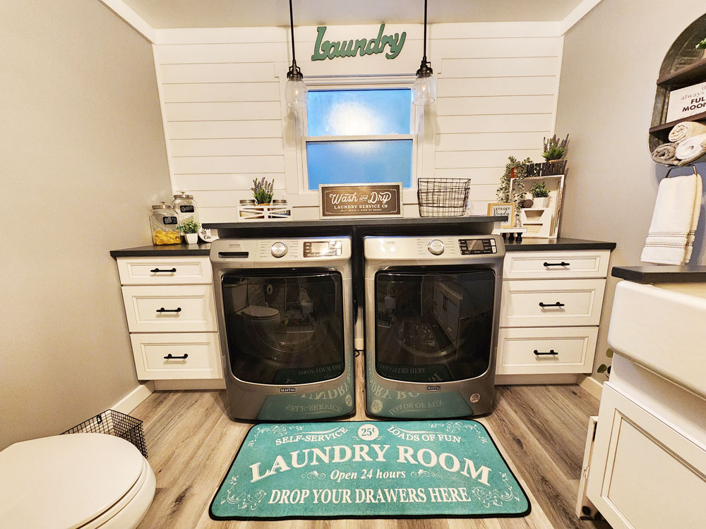 rustic laundry room with white cabinets