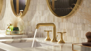 gold bathroom faucet with white tile and gold fixtures