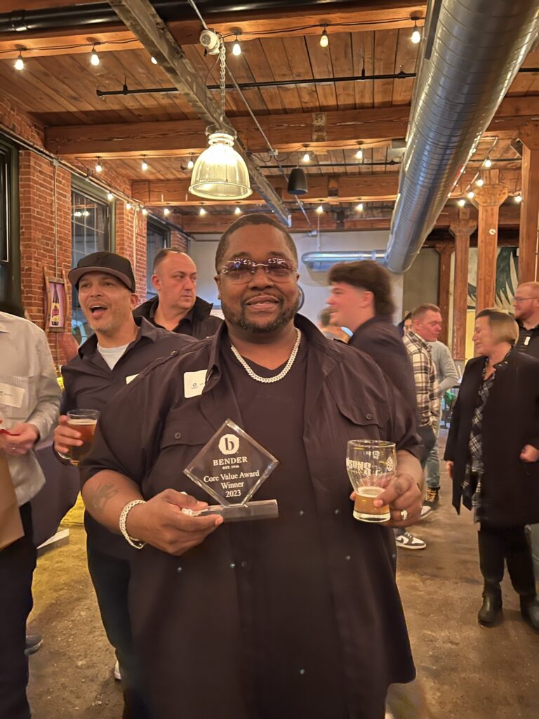 man posing with award plaque