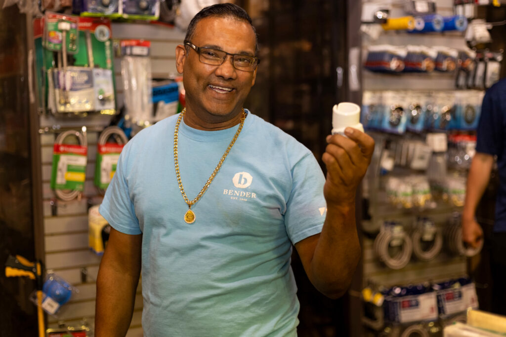 man posing with plumbing parts