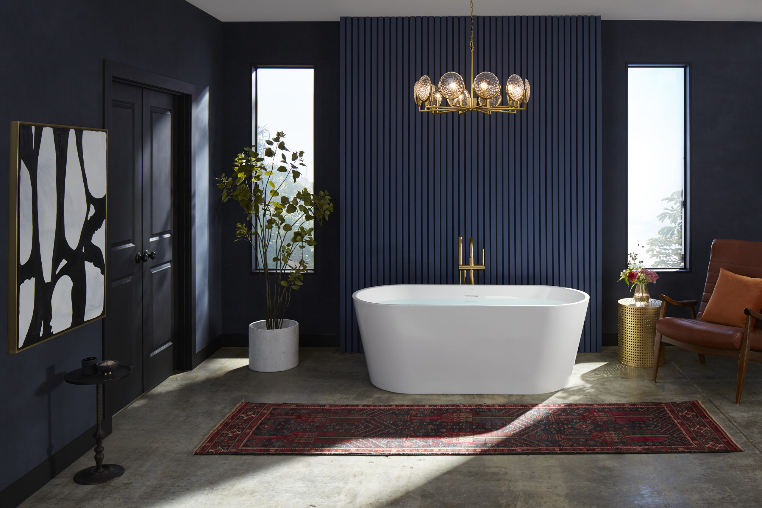 white freestanding tub with gold bath filler