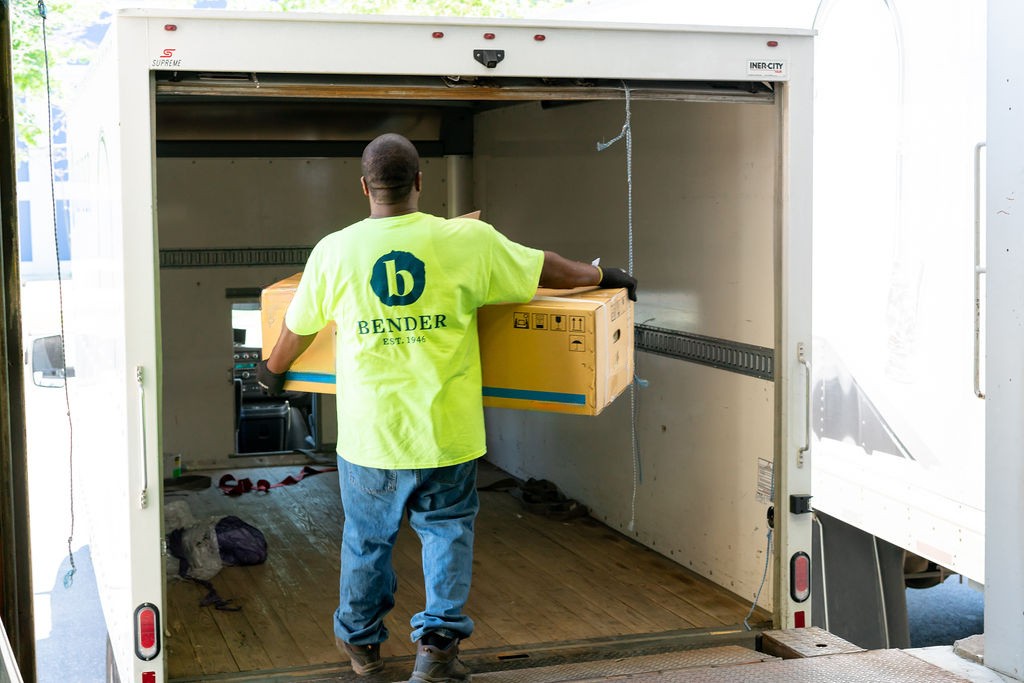 man carrying box onto truck